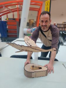 Terry leaning over a wooden model of a goose on a plinth